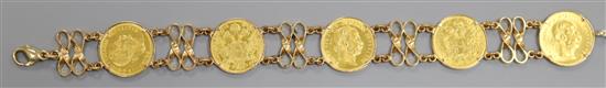 A 585 yellow metal bracelet set with five Austro Hungarian gold coins, 21.5cm.